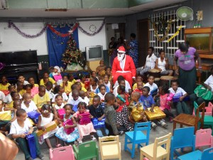 Black Santa and happy kids singing Christmas charols